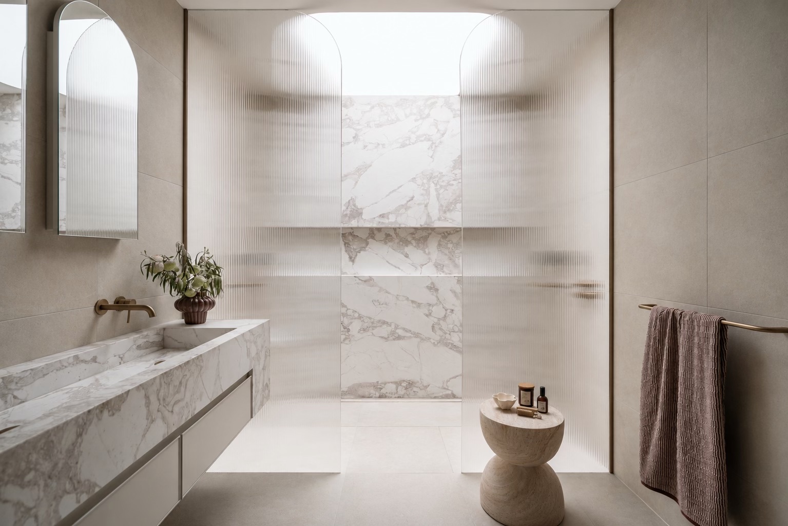 Bathroom with marble vanity and fluted glass shower